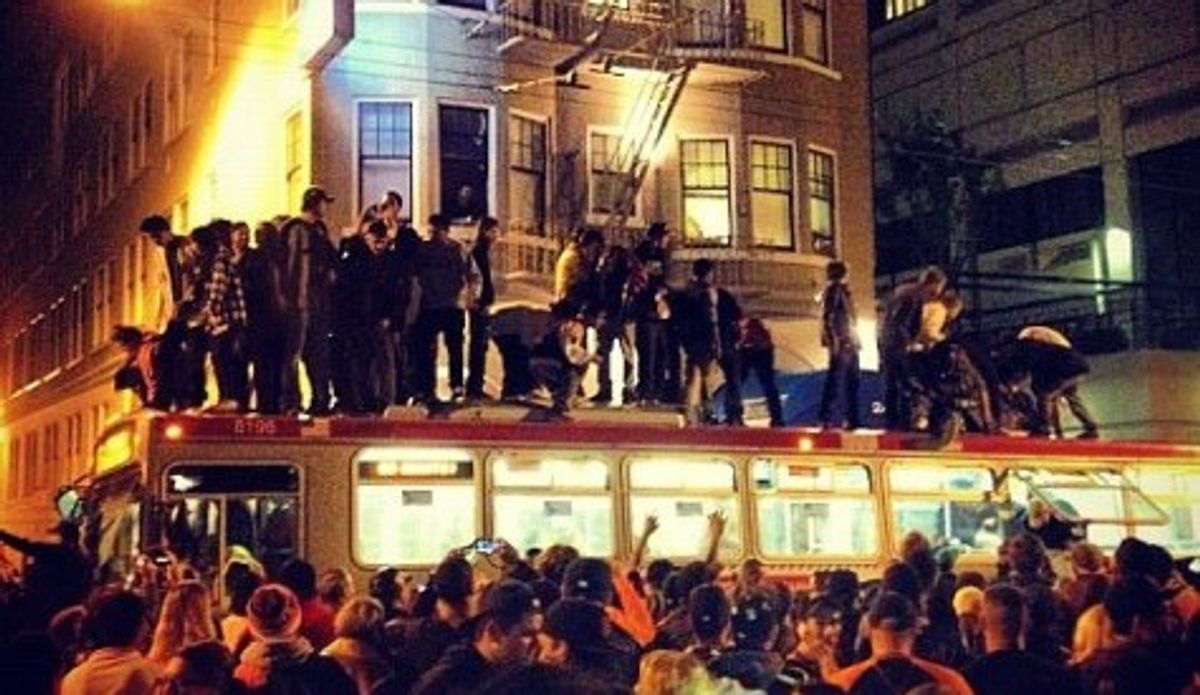  Revelers stand atop a San Francisco bus (Twitter)        
