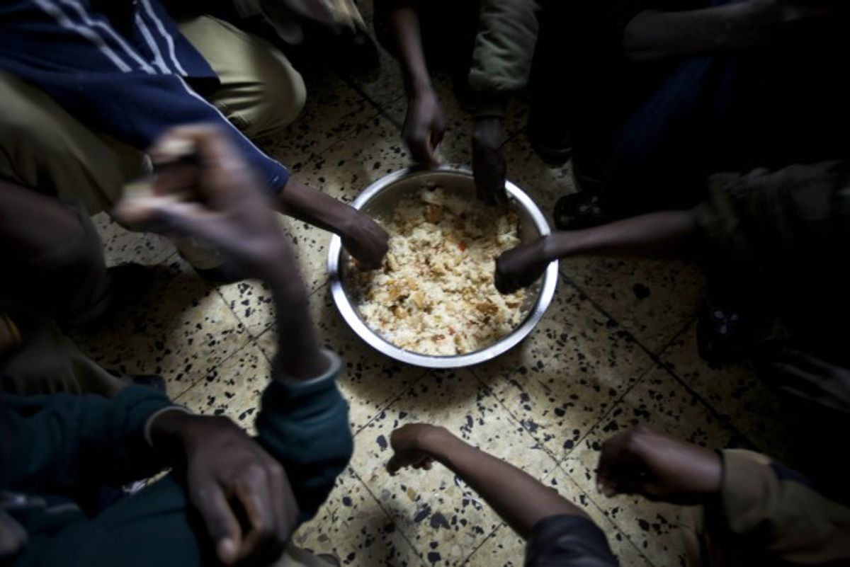 African refugees share breakfast at a shelter in Tel Aviv.  (AP/Oded Balilty)