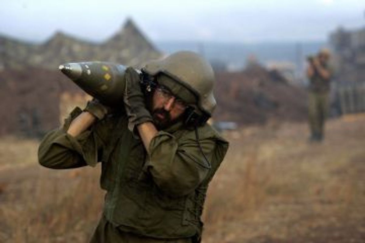 An Israeli soldier carries shells on the border with Lebanon in 2006                    (David Furst//Getty Images)
