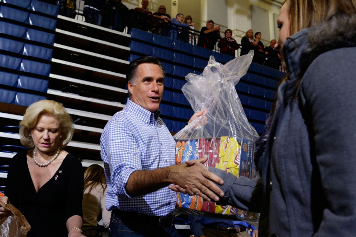 Mitt Romney accepts donations of food as he participates in an Ohio campaign event collecting supplies for victims of Hurricane Sandy.     (AP/Charles Dharapak)