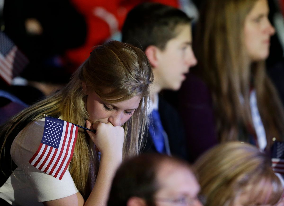 A supporter reacts to voting results displayed on a television screen during Republican presidential candidate and former Massachusetts Gov. Mitt Romney's election night rally.   (AP/David Goldman)