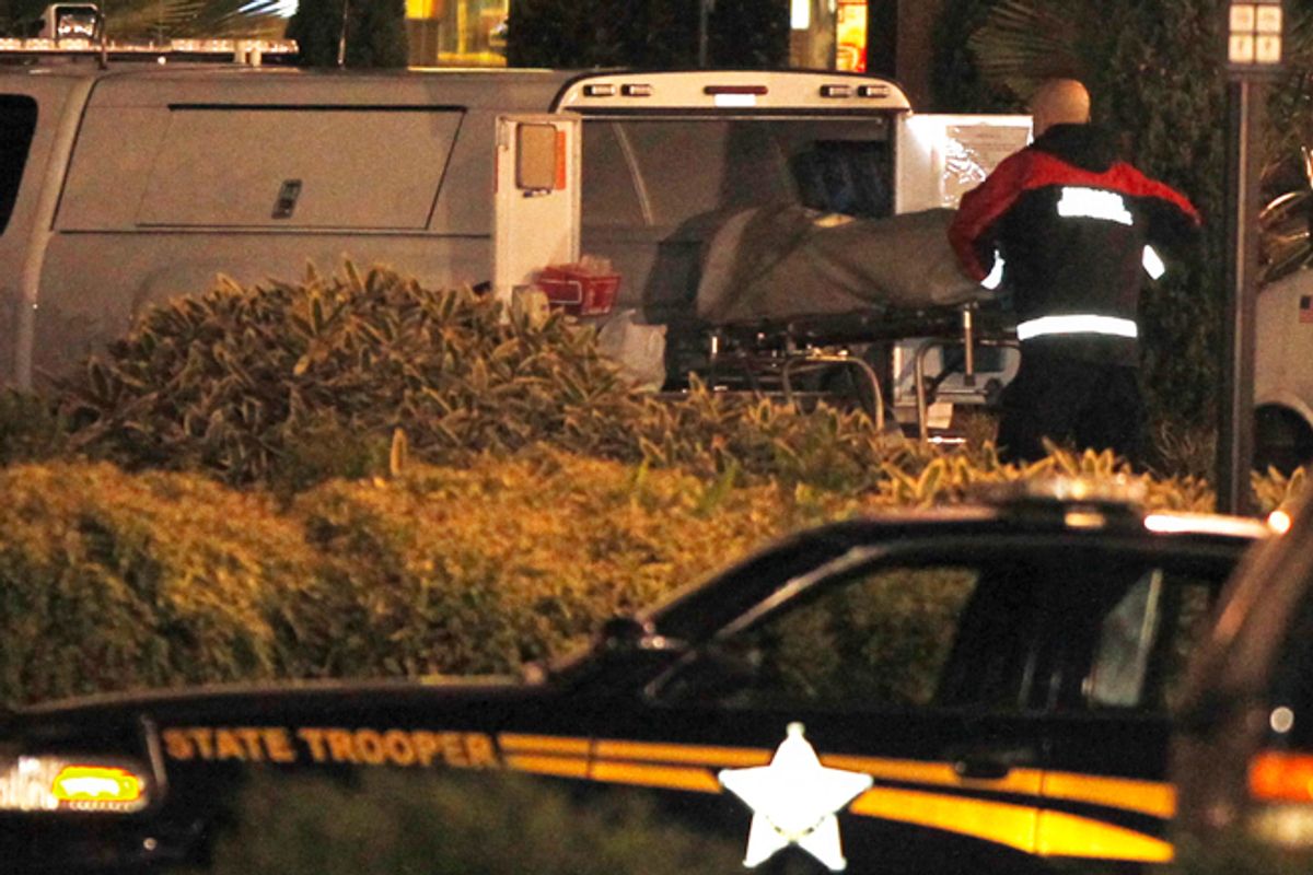 An Oregon State Medical Examiner loads a body into a van at the Clackamas Town Center shopping mall in Portland, Oregon December 11, 2012. (Reuters/Steve Dipaola)