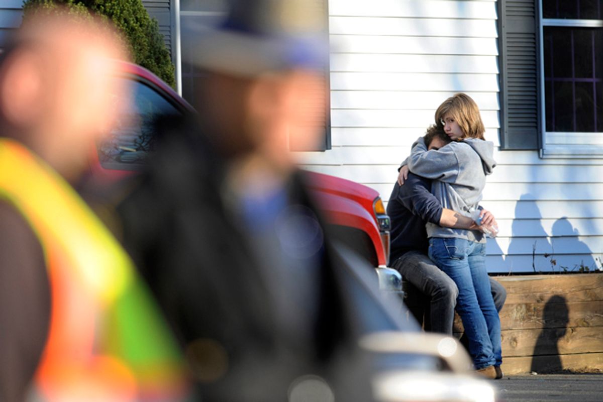 People embrace at a firehouse staging area for family around near the scene of a shooting at the Sandy Hook Elementary School in Newtown, Conn., Friday, Dec. 14, 2012.  (AP Photo/Jessica Hill)