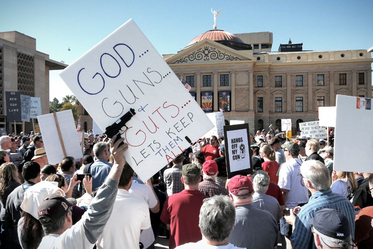 Gun rights supporters stand outside the Capitol Sat, Jan. 19, 2013 in Phoenix during a Guns Across America rally.           (AP/Matt York)