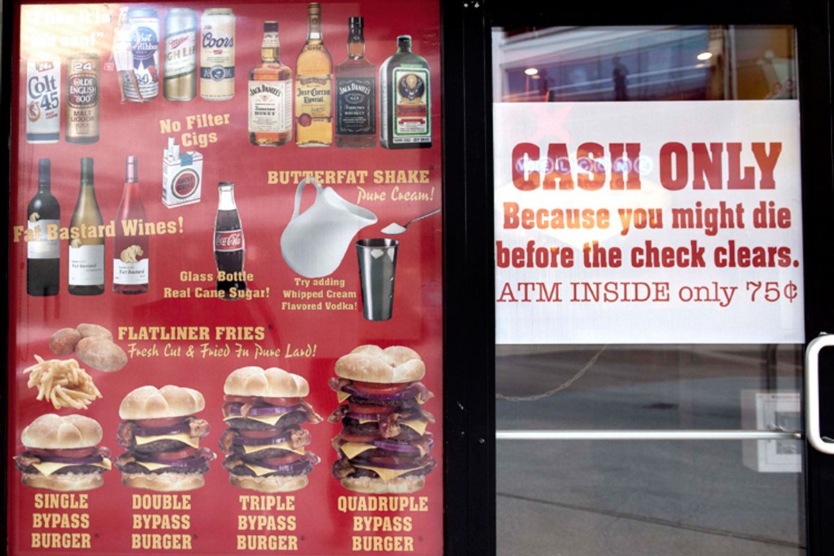 Menu offerings and warnings are posted in the window of the Heart Attack Grill.   (AP/Julie Jacobson)