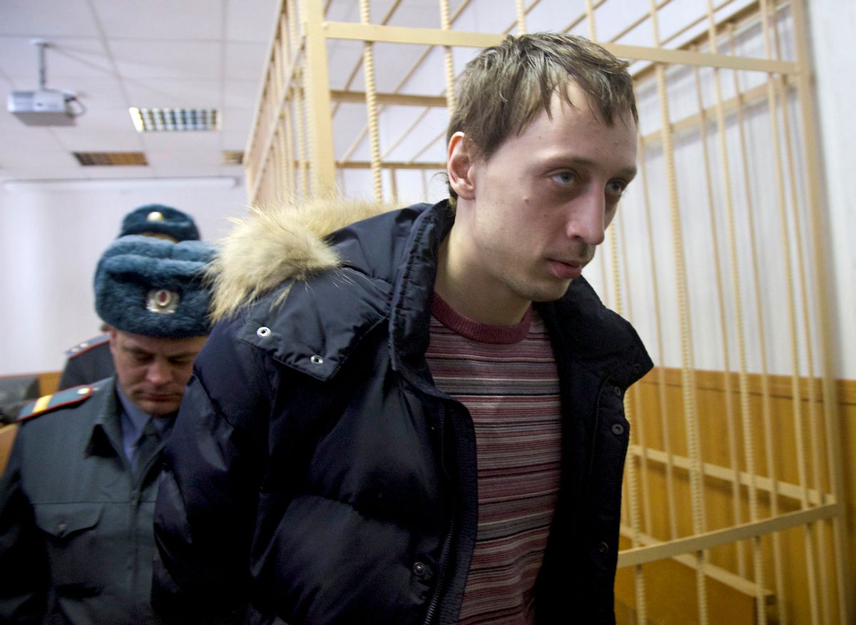 Pavel Dmitrichenko, foreground, is escorted out of a courtroom in Moscow, Russia, on Thursday, March 7, 2013.   (AP/Ivan Sekretarev)