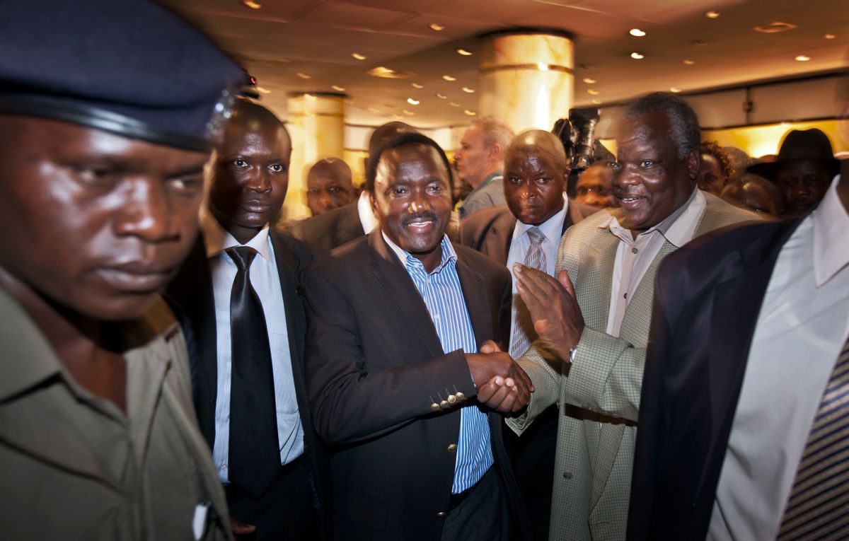 Kalonzo Musyoka, center, Kenya's current Vice President and running mate of presidential candidate Raila Odinga, leaves after speaking at a press conference in Nairobi, Kenya Thursday, March 7, 2013. The coalition of Kenya's prime minister Raila Odinga says the vote tallying process now under way to determine the winner of the country's presidential election "lacks integrity."   (AP/Ben Curtis)