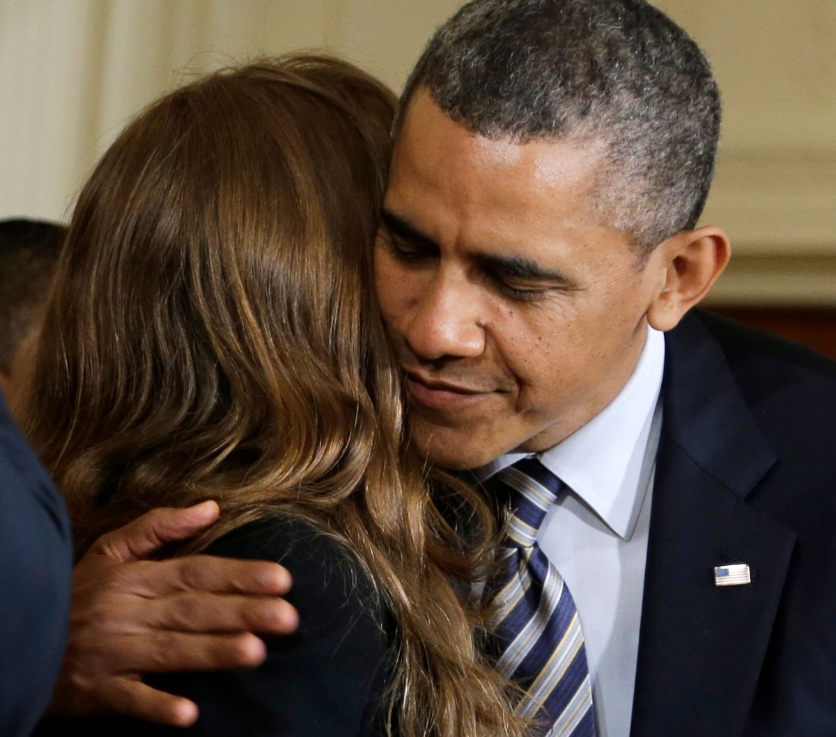 President Barack Obama hugs Katerina Rodgaard, a Maryland dance instructor who knew one of the victims of the Virginia Tech shootings, after she introduced him in the East Room of the White House in Washington, Thursday, March 28, 2013.        (AP/Carolyn Kaster)