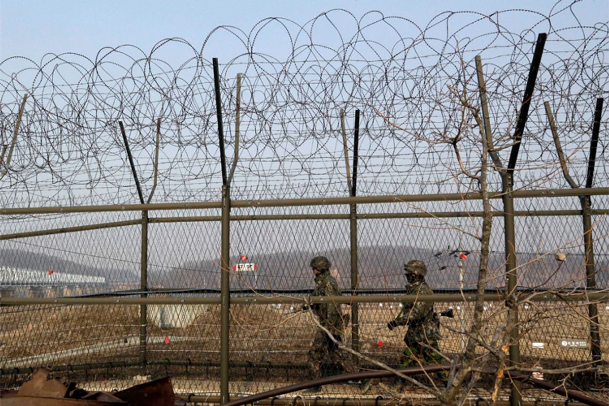 South Korean army soldiers patrol along a barbed-wire fence at the Imjingak Pavilion near the border village of Panmunjom.        (AP Photo/Lee Jin-man)
