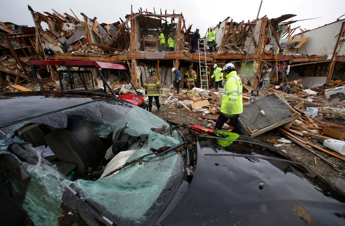 A smashed car sits in front of an apartment complex destroyed by an explosion at a fertilizer plant in West, Texas.     (AP /LM Otero)