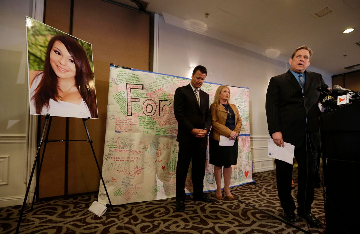 Larry Pott, right, father of Audrie Pott, who committed suicide after a sexual assault, answers questions as family representative Robert Allard, left, and Sheila Pott, mother of Audrie, listen during a news conference Monday.      (AP/Eric Risberg)