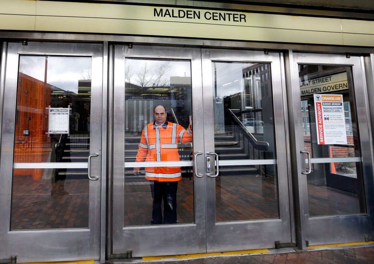 An MBTA transit official closes a door at Malden Center station in Malden, Mass.          (AP/Elise Amendola)