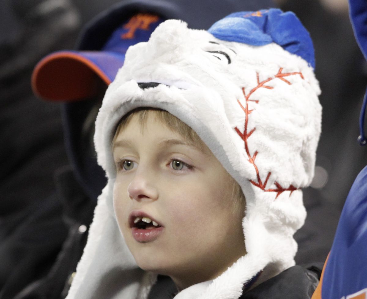 A New York Mets fan is bundled up against the cold during the Mets' baseball game against the San Diego Padres, Wednesday, April 3, 2013, in New York.       (AP/Mark Lennihan)