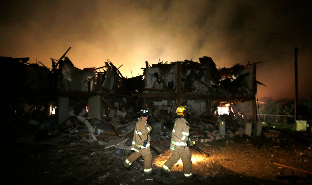 Firefighters check a destroyed apartment complex near the fertilizer plant that exploded earlier in West, Texas, in this photo made early Thursday, April 18, 2013.      (AP/LM Otero)