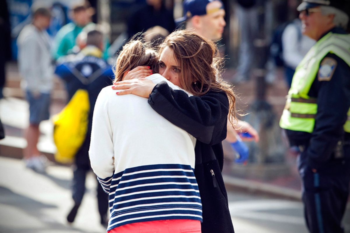 A woman comforts another, after explosions interrupted the 117th Boston Marathon in Boston, Massachusetts April 15, 2013.    (Reuters/Dominick Reuter)