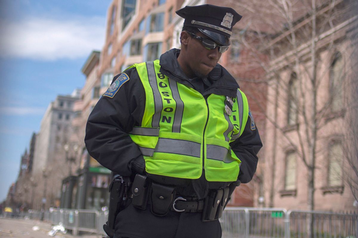 A Boston police officer stands inside the barricaded entrance at Boylston Street near the finish line of the Boston Marathon in Boston, Massachusetts April 16, 2013.    (Reuters/Shannon Stapleton)