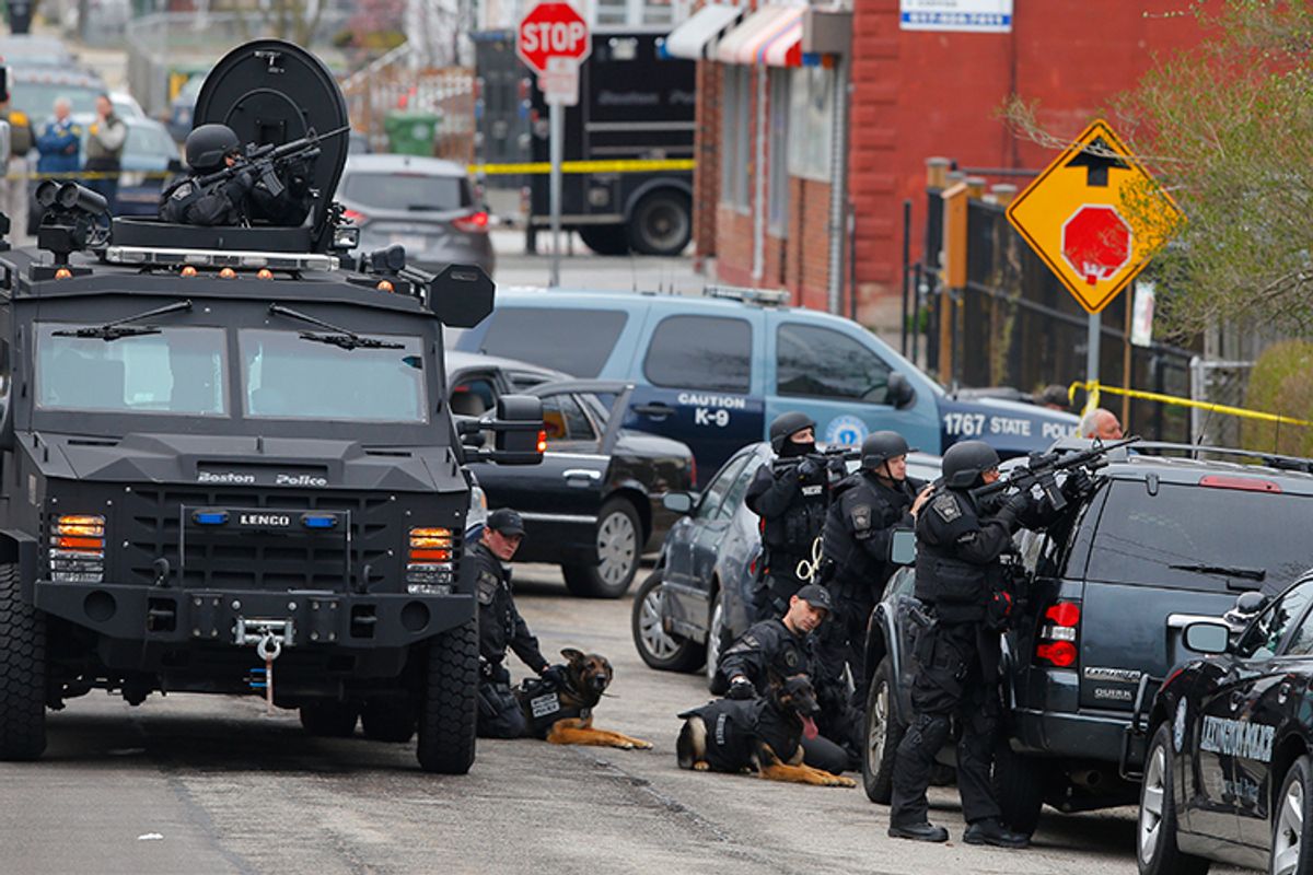 Police officers take position during a search for the Boston Marathon bombing suspects in Watertown, Massachusetts April 19, 2013.   (Brian Snyder / Reuters)