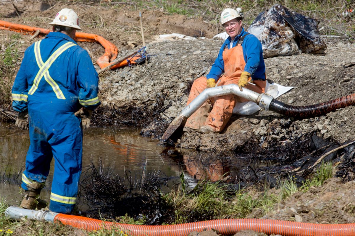 Emergency crews work to clean up an oil spill near Interstate 40 in Mayflower, Arkansas March 31, 2013.     (Reuters/Jacob Slaton)