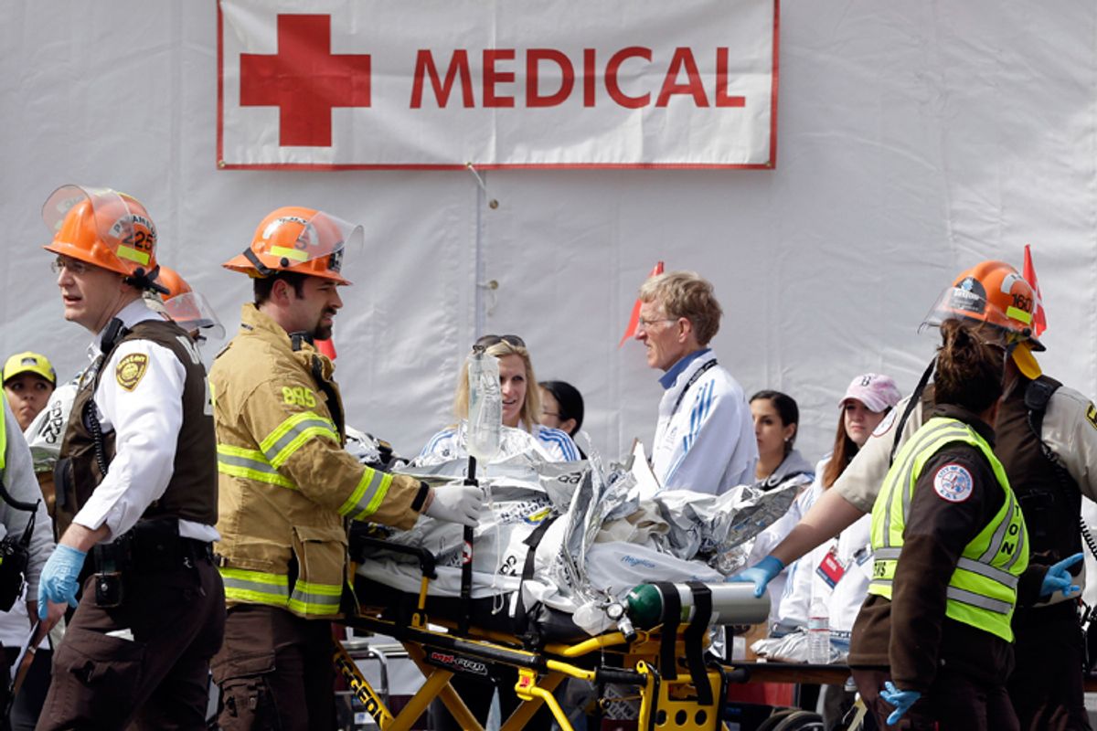 Medical personnel work outside the medical tent in the aftermath of two blasts which exploded near the finish line of the Boston Marathon in Boston, Monday, April 15, 2013.         (AP/Elise Amendola)