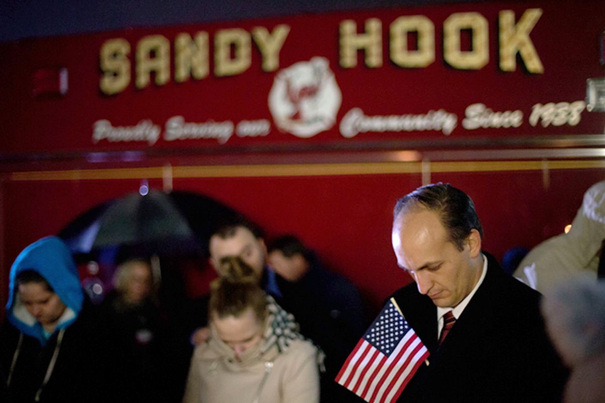 Mourners listen to a memorial service over a loudspeaker outside Newtown High School for the victims of the Sandy Hook Elementary School shooting, Sunday, Dec. 16, 2012, in Newtown, Conn.         (AP/David Goldman)