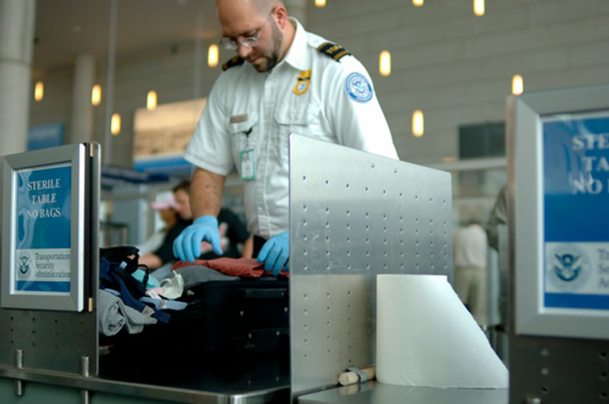 A TSA agent searches luggage at an airport       (Carolina K. Smith)