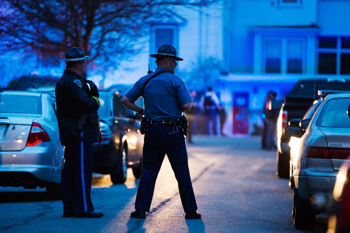 Law enforcement officials stand at the scene on Franklin St. as the search for Dzhokhar Tsarnaev, the surviving suspect in the Boston Marathon bombings, comes to an end in Watertown, Massachusetts April 19, 2013.     (Reuters/Lucas Jackson)