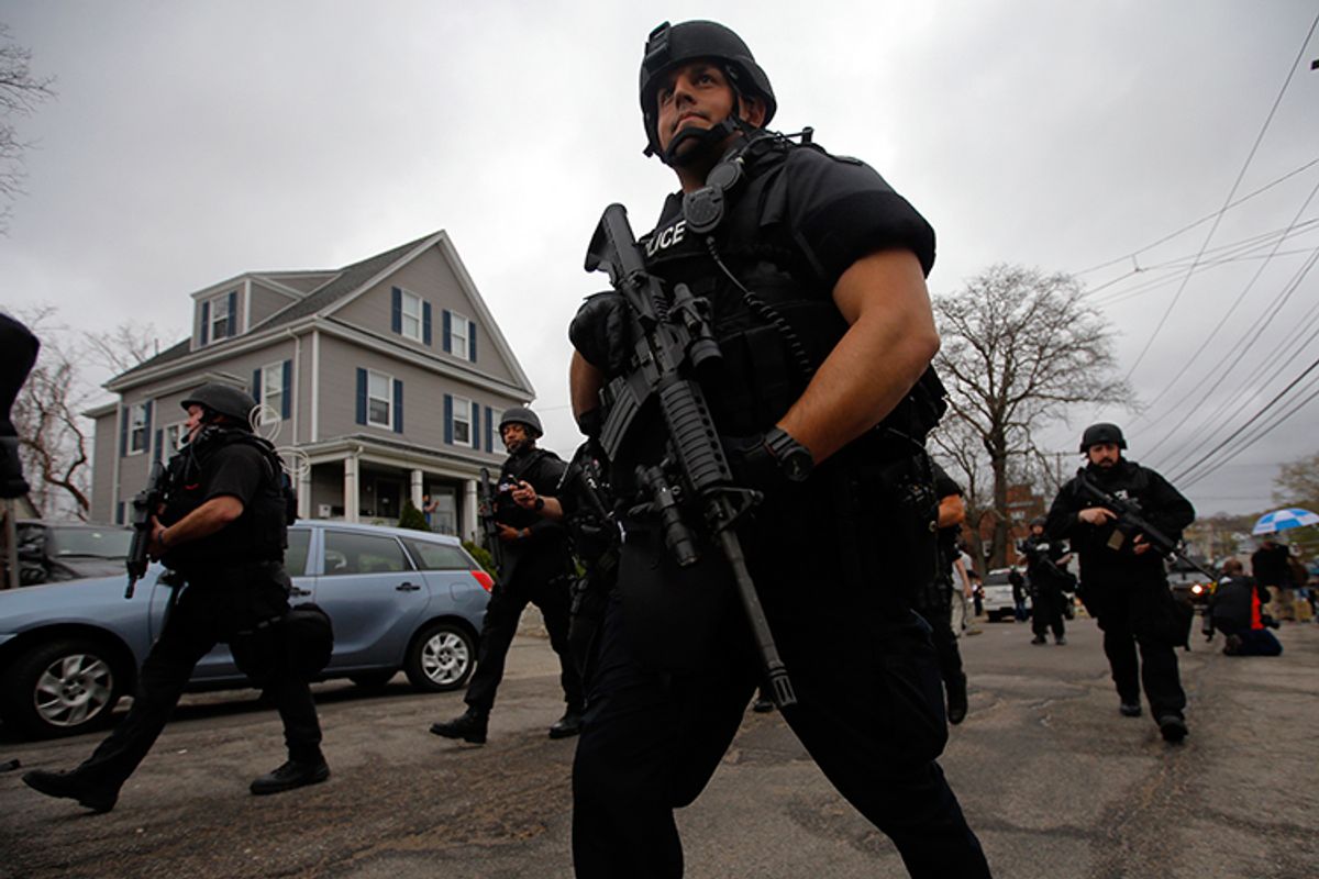 Police officers search house to house for the second suspect in the Boston Marathon bombings in a neighborhood of Watertown, Massachusetts April 19, 2013.       (Reuters/Brian Snyder)