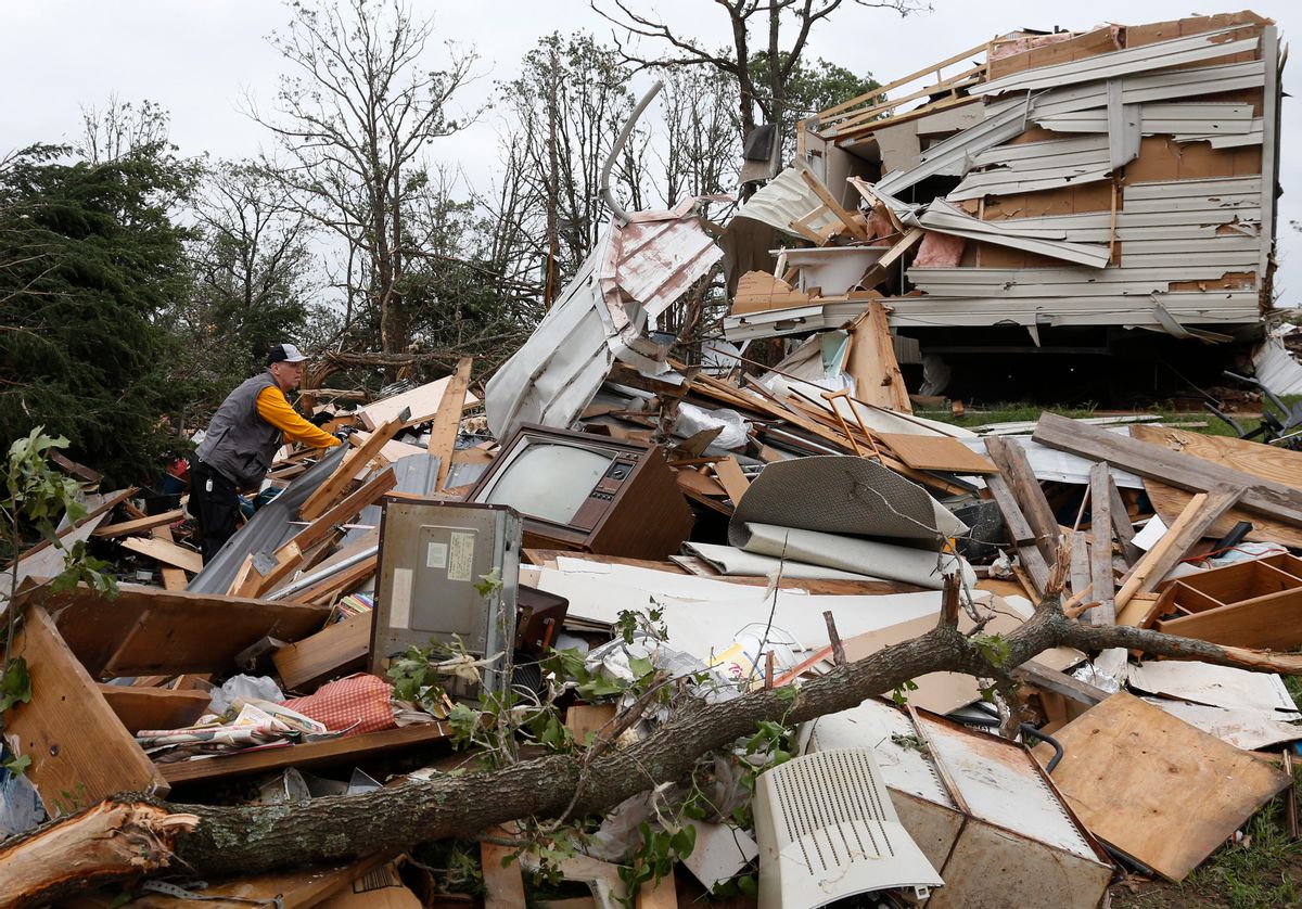 Lee Hoyle, of Chickasaw Nation search and rescue, digs through the debris of a mobile home in the Steelman Estates Mobile Home Park, destroyed by Sunday's tornado, near Shawnee, Okla., Monday, May 20, 2013. (AP/Sue Ogrocki)