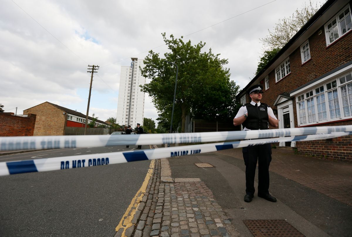 Police officers guard a cordon set up around a crime scene where one man was killed was killed in Woolwich, southeast London May 22, 2013.          (REUTERS/Stefan Wermuth)