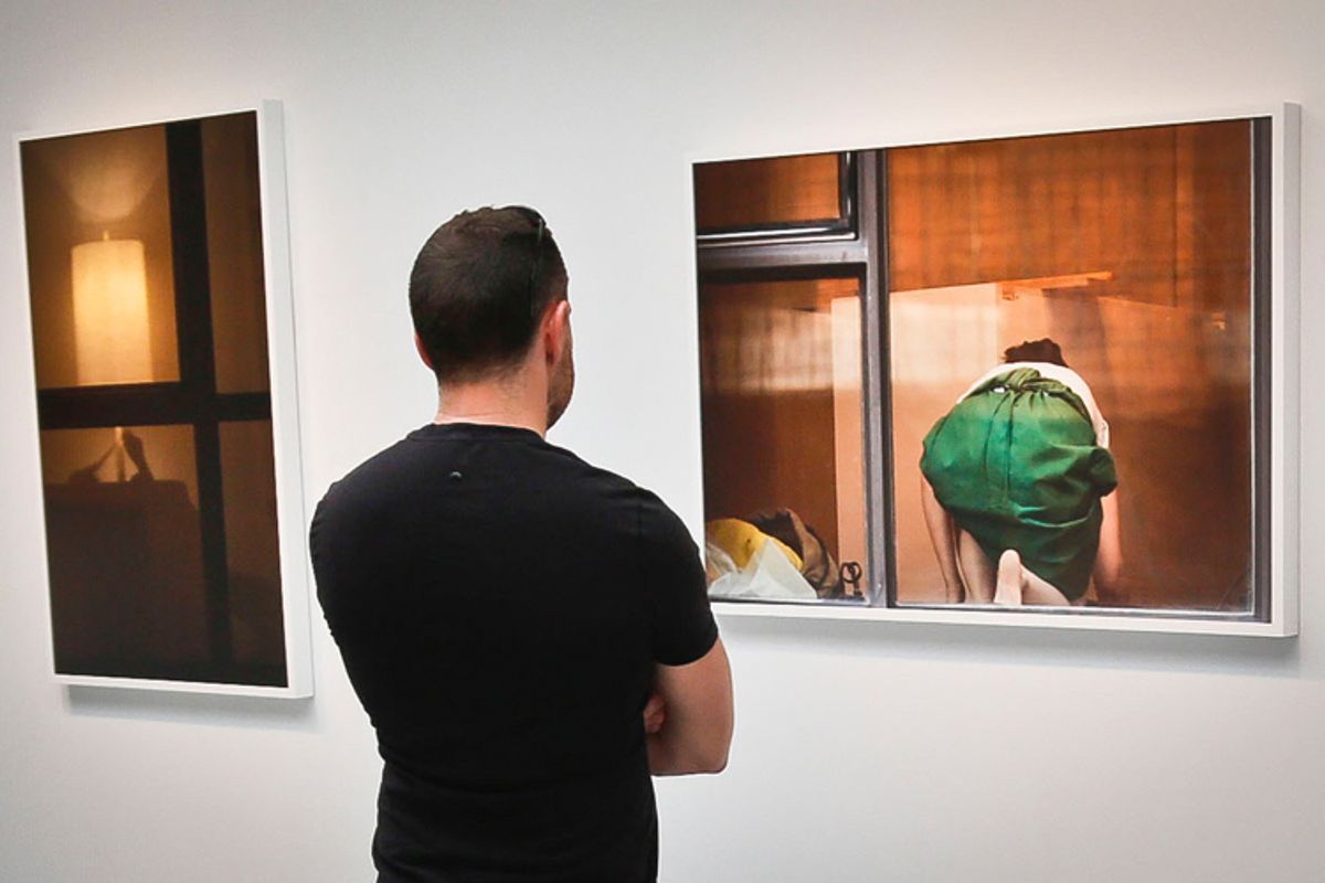 A visitor views the photography of Arne Svenson on Thursday, May 16, 2013 at the Julie Saul Gallery in New York.   (AP/Bebeto Matthews)