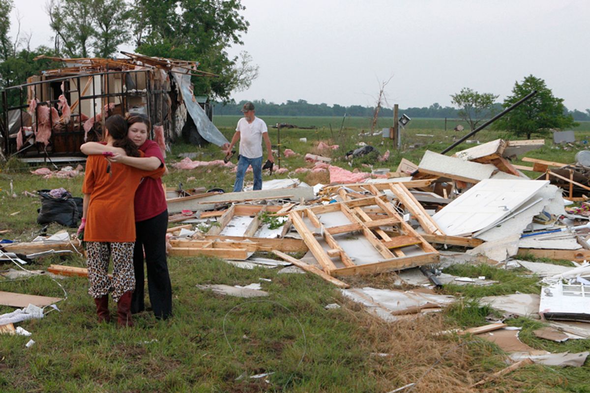Leah Hill (L), of Shawnee, Oklahoma, is hugged by friend Sidney Sizemore, as they look through Hill's scattered belongings from her home which was destroyed by a tornado, west of Shawnee, Oklahoma May 19, 2013.                (Reuters/Bill Waugh)