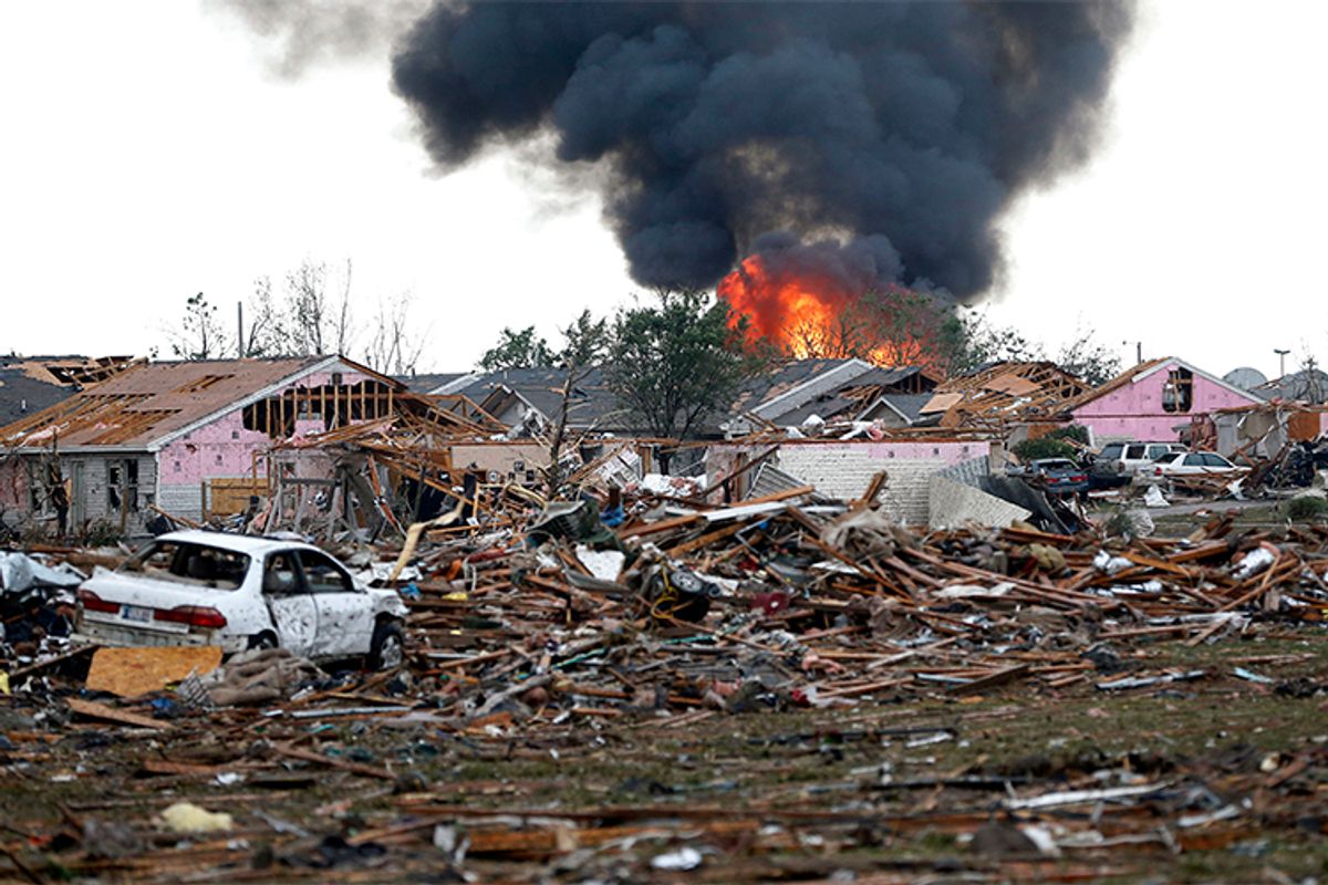 A fire burns in the Tower Plaza Addition in Moore, Okla., following a tornado Monday, May 20, 2013.         (AP/Sue Ogrocki)