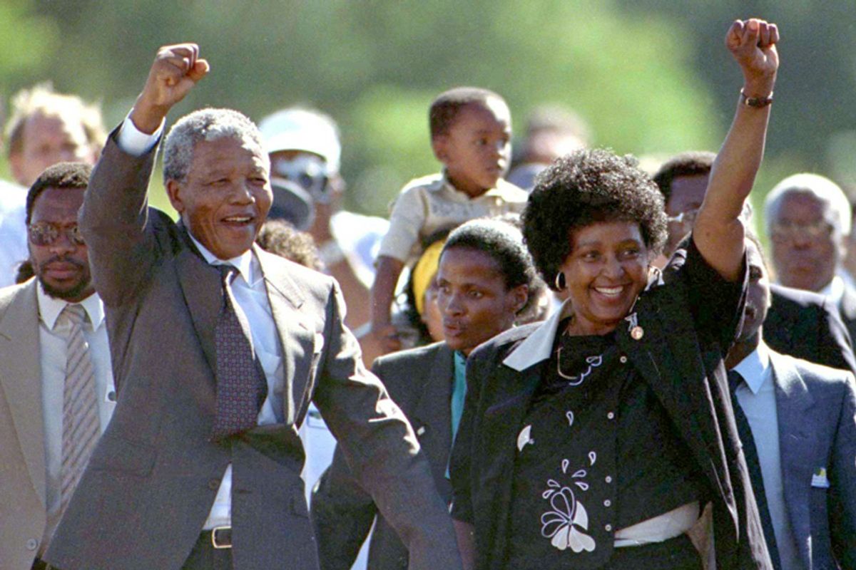 Nelson Mandela is accompanied by his former wife Winnie, moments after his release from prison February 11, 1990 after serving 27 years in jail.      (© Reuters Photographer / Reuters)