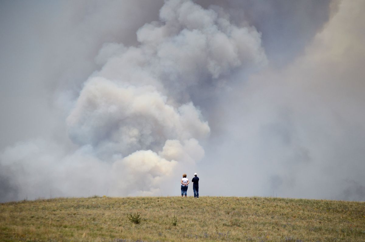 Chris and Christine Walker watch the Black Forest Fire gain steam as it burns out of control for a second straight day near Colorado Springs, Colo. on Wednesday, June 12, 2013.          (AP/Bryan Oller)