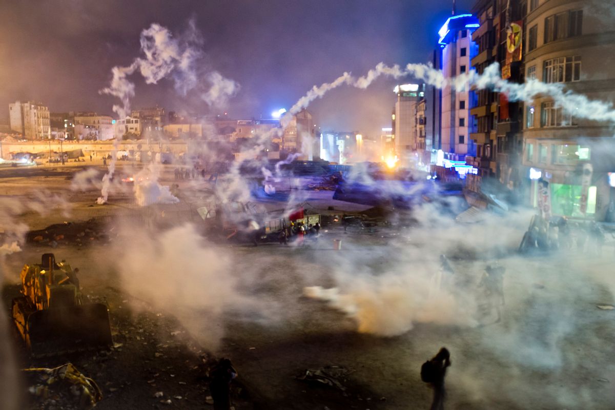 Taksim Square is flooded by tear gas as clashes between protesters and riot police continue into the night in Istanbul Tuesday, June 11, 2013.  (AP/Vadim Ghirda)