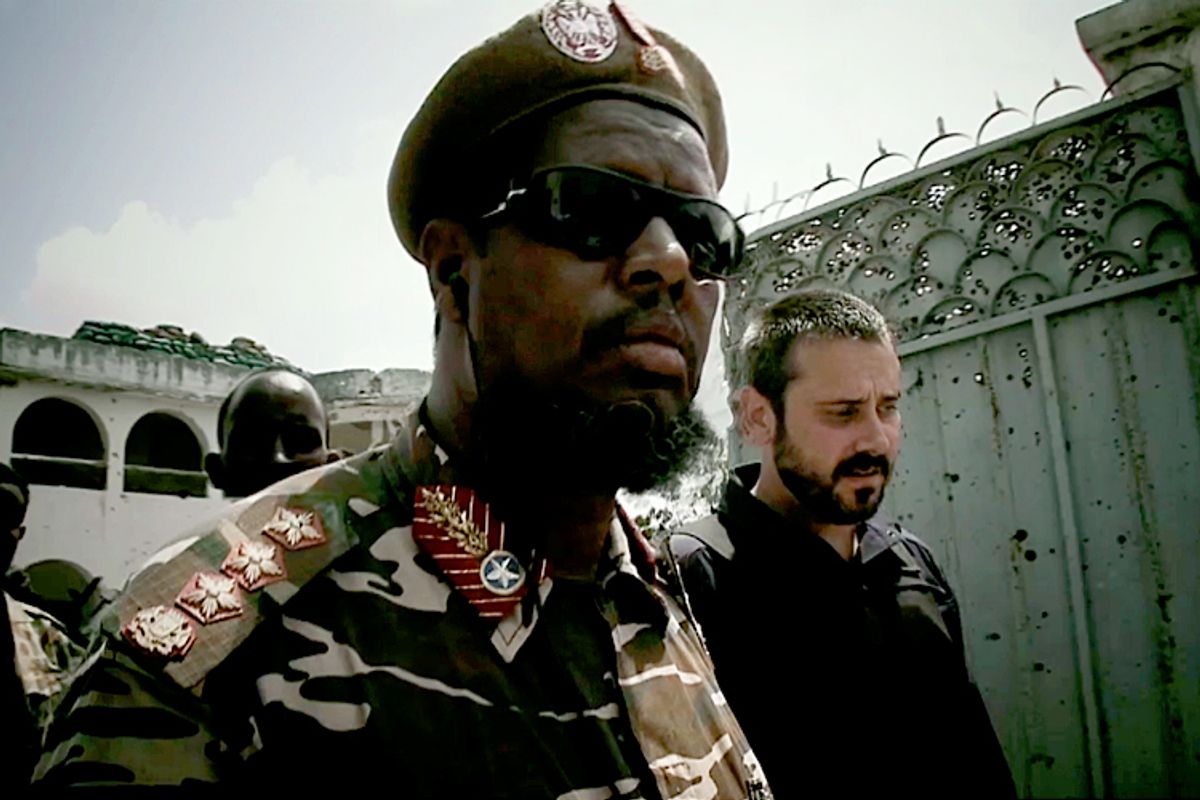Investigative reporter Jeremy Scahill (right) with a U.S.-sponsored Somali warlord in a scene from "Dirty Wars."  