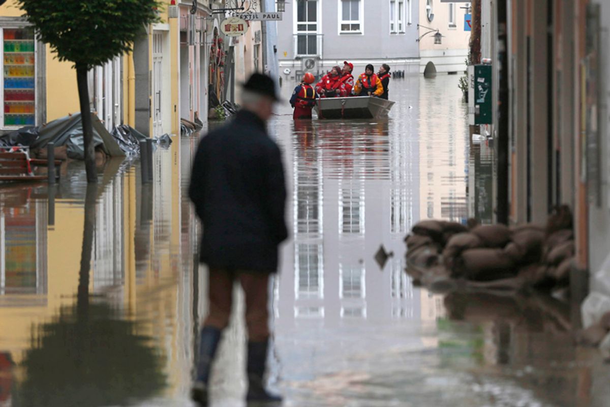 Red cross teams use boats to evacuate people  after river Danube flooded the old town of Passau, southern Germany, on Tuesday, June 4, 2013. Raging waters from three rivers have flooded large parts of the southeast German city following days of heavy rainfall in central Europe.   (AP Photo/Matthias Schrader)