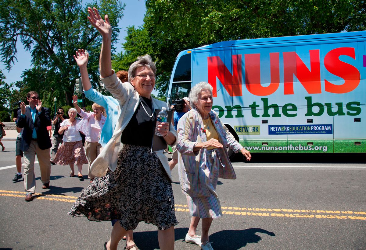 Sister Simone Campbell, left, and Sister Diane Donoghue, right, lead the way as the the "Nuns on the Bus" arrive on Capitol Hill in Washington, Monday, July 2, 2012, after a nine-state tour to bring stories of hardship to Congress. Sister Simone Campbell is executive director of Network, a liberal Catholic social justice lobby in Washington.  (AP/J. Scott Applewhite)
