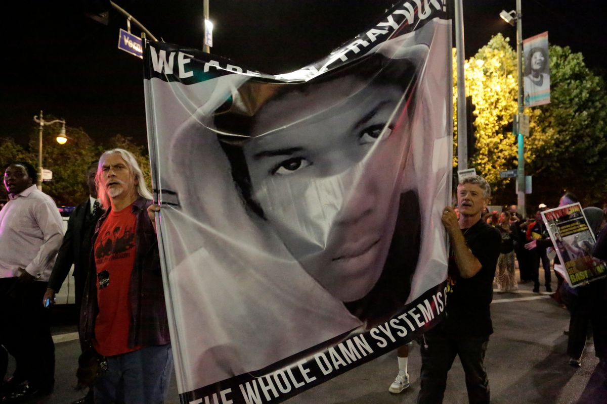 Protesters hold an image of Trayvon Martin while marching in the Leimert Park area of Los Angeles, California, following the George Zimmerman verdict             (Reuters/Jason Redmond)