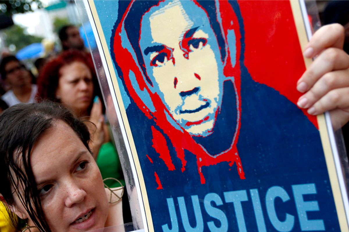  Protester holds an image of Trayvon Martin at a rally in Miami, Florida         (Reuters/Andrew Innerarity)
