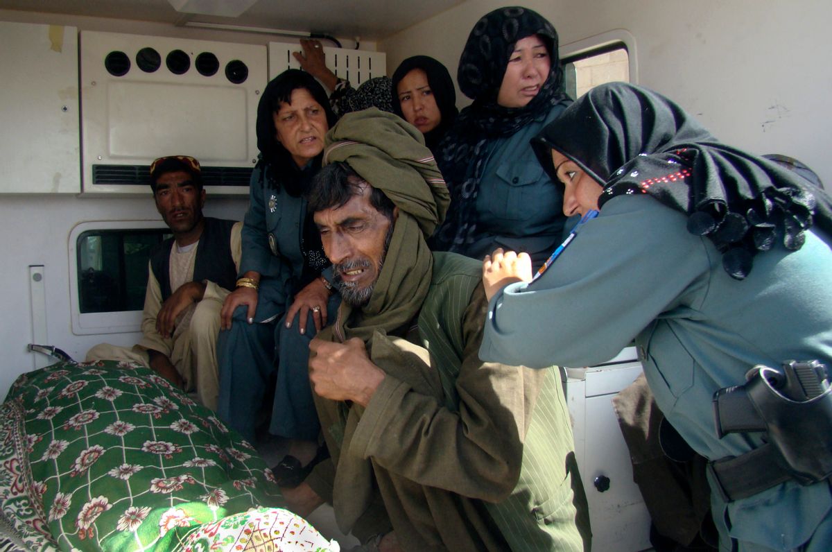 Afghan policewomen and relatives grieve over the body of the top policewoman in Helmand province, Negar.        (AP Photo/Abdul Khaliq)