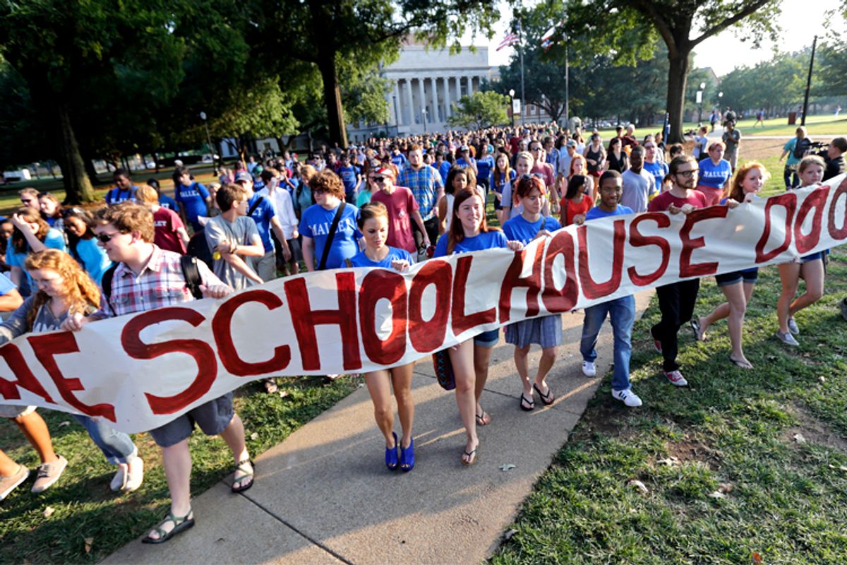Students and faculty members of the Univ. of Alabama march across the campus to oppose racial segregation among its Greek-letter social organizations    (AP/Dave Martin)