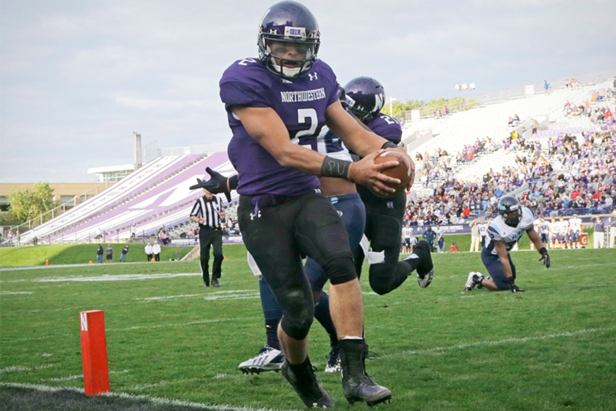 Northwestern quarterback Kain Colter wears the letters "APU" on his wristband during a game against Maine in Evanston, Ill., Sept. 21, 2013.      (AP/Nam Y. Huh)
