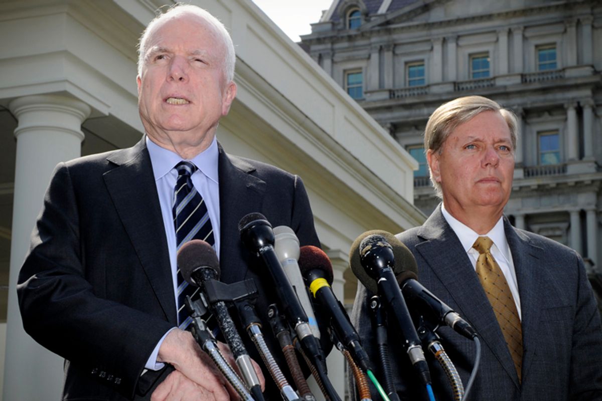 John McCain addresses the media as Lindsey Graham listens, on possible military action against Syria, in Washington September 2, 2013.                 (Reuters/Mike Theiler)