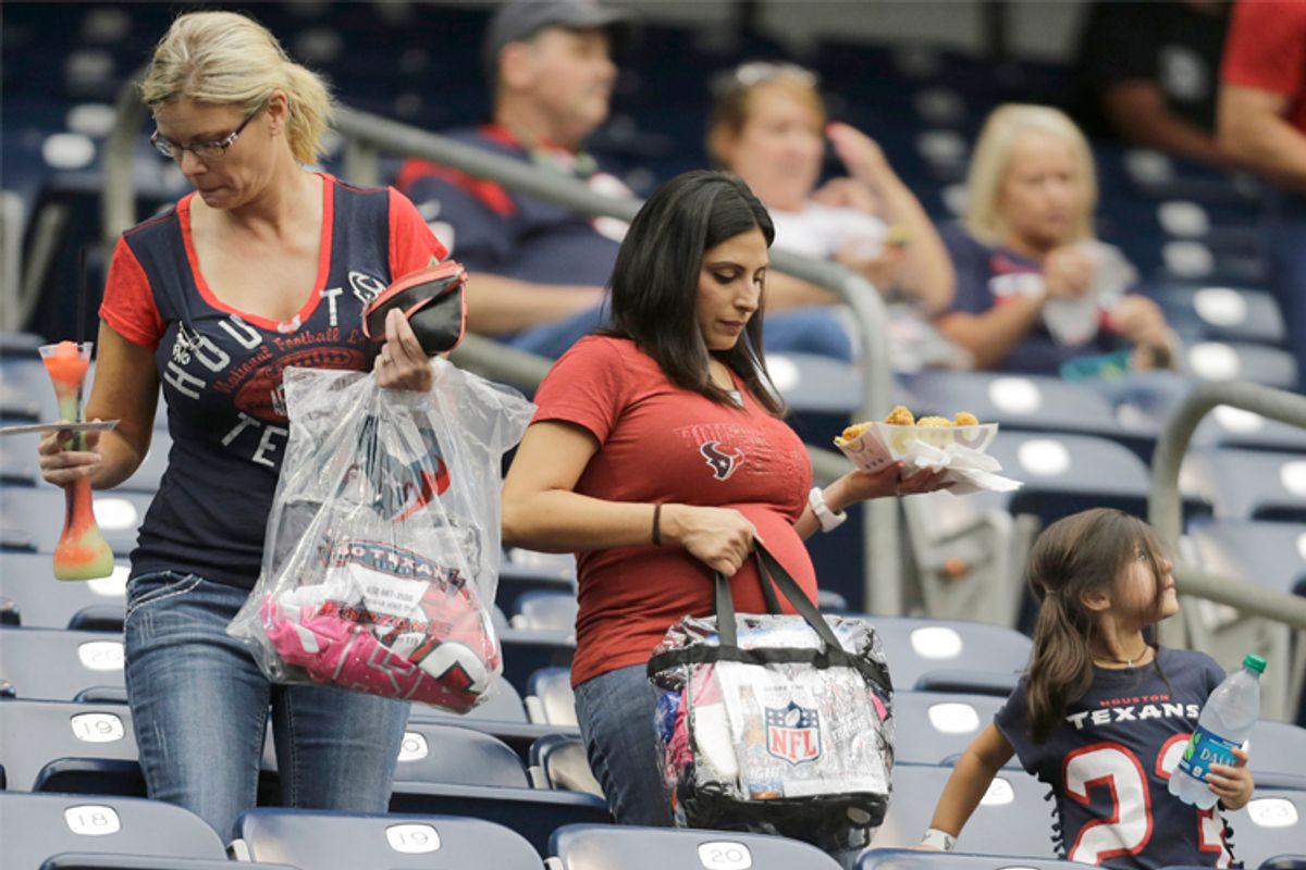 With their belongings in clear plastic bags, fans arrive before a preseason game, Aug. 25, 2013, in Houston.       (AP/Eric Gay)