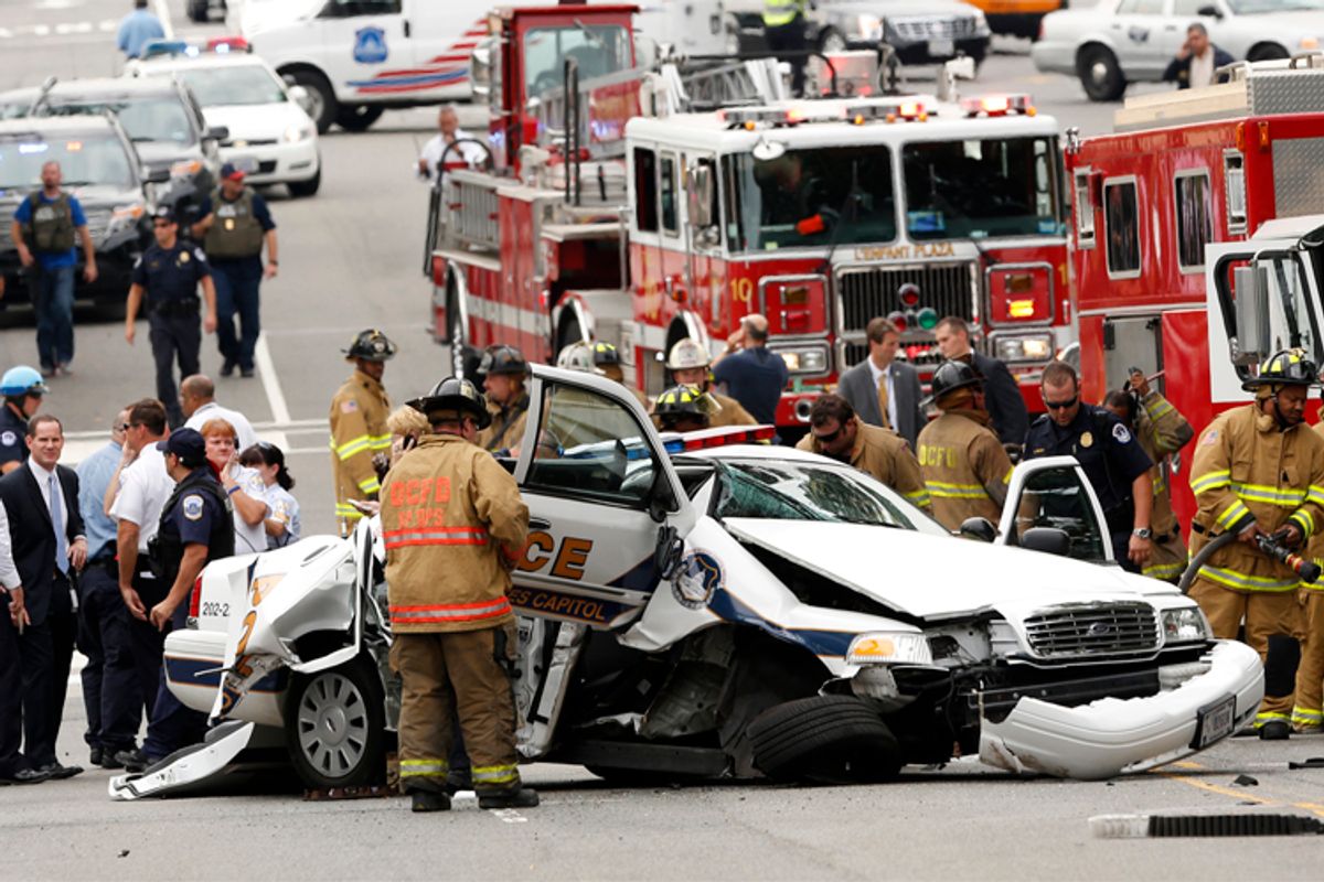 Rescue personnel stand around a smashed U.S. Capitol Police car following a shooting near the U.S. Capitol in Washington, October 3, 2013.              (Reuters/Kevin Lamarque)
