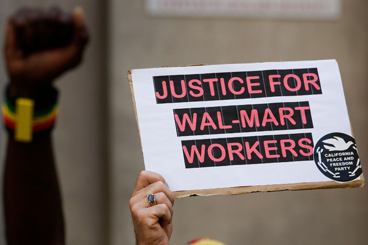 A protester holds up a sing during a protest against Walmart on Thursday, Sept. 5, 2013, in Los Angeles.                                    (AP/Jae C. Hong)