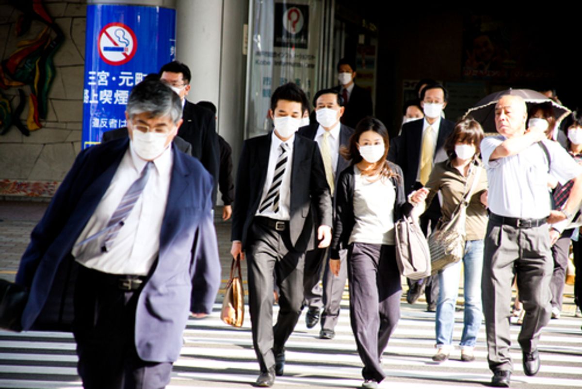KOBE, JAPAN: People on the street wear face masks because of the outbreak of swine flu near Sannomiya JR station May 20, 2009   (Hinochika/Shutterstock)