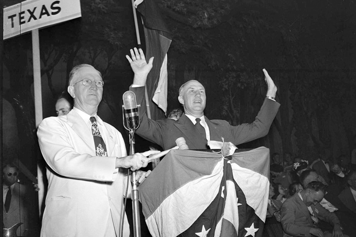 South Carolina Gov. Strom Thurmond reacts to applause from Dixiecrat's State's Rights Convention delegates in Birmingham, Ala., July 17, 1948. At left is Walter Sillers, convention chairman.      (AP)