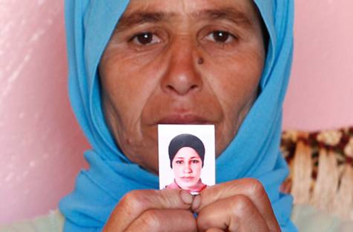 Zohra Filali holds a photo of her daughter, Amina   (AP)